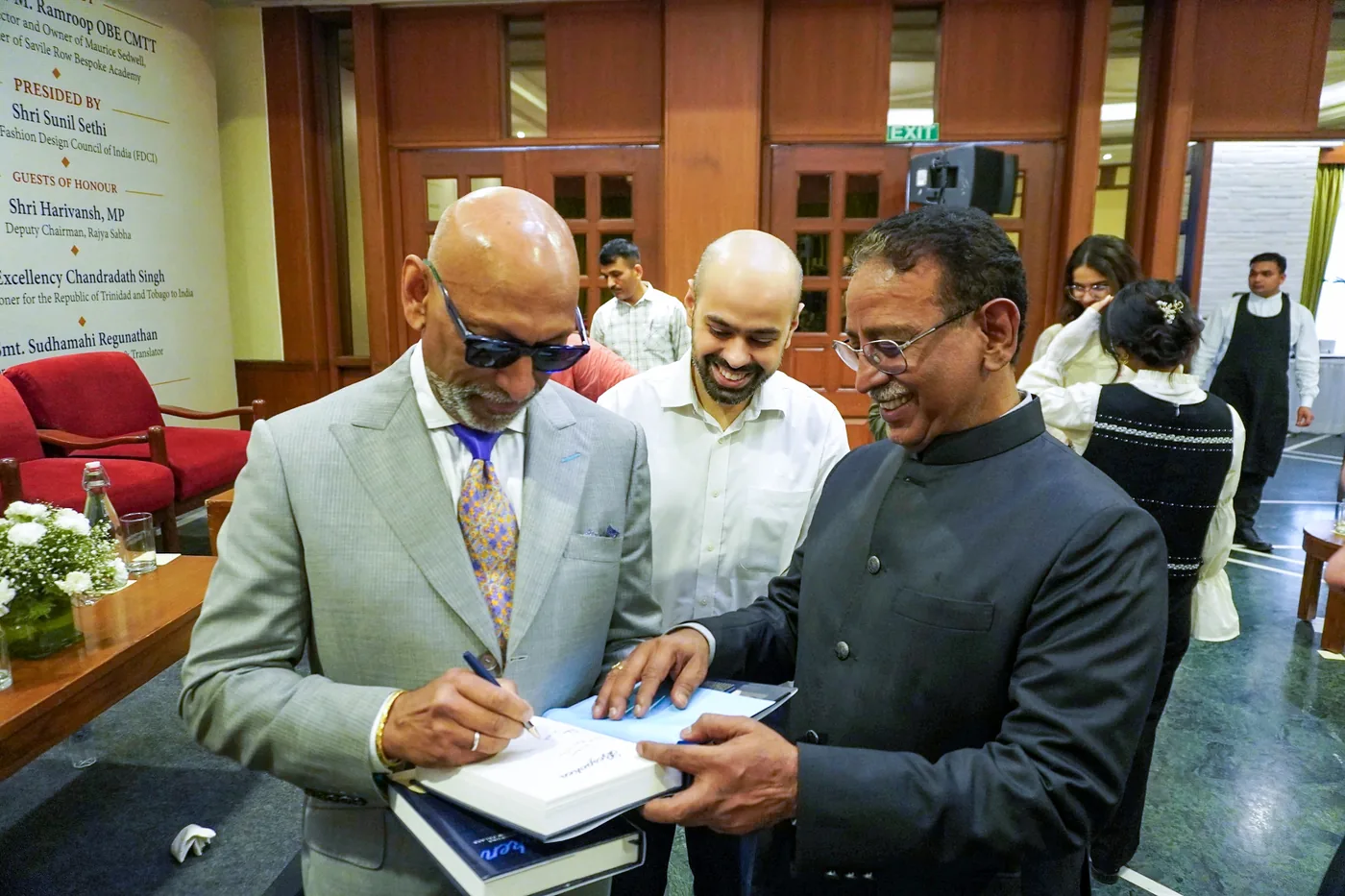 Prof. Andrew M. Ramroop signs a copy of Bespoken for Sushant Kumar of MLabs Digital