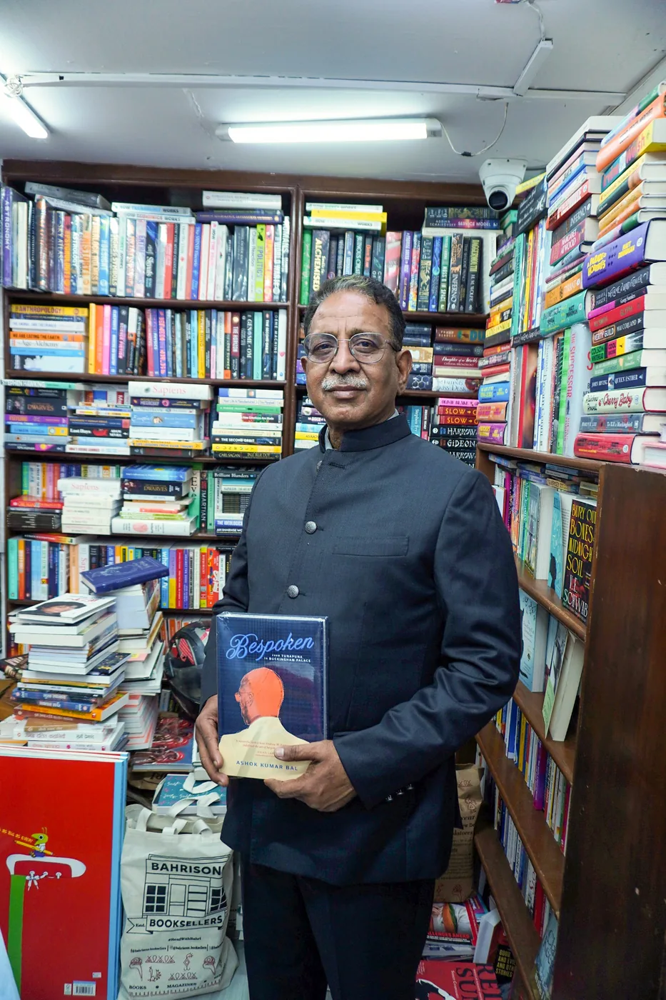Ashok Kumar Bal holds a copy of Bespoken at a Delhi bookstore